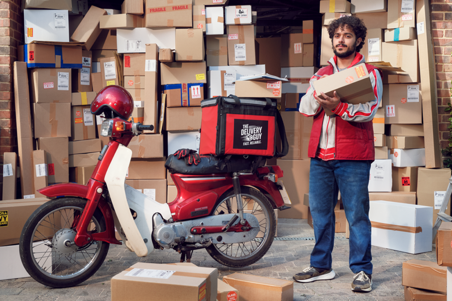 A man surrounded by boxes for delivery